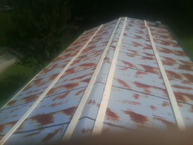 Rusted metal roof panels with new wood purlins before replacement — Storm Damage Roof Repair in Saint Petersburg by Roofing Brothers